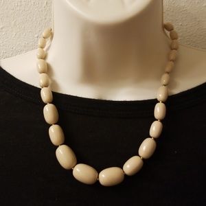 Tan beaded necklace.